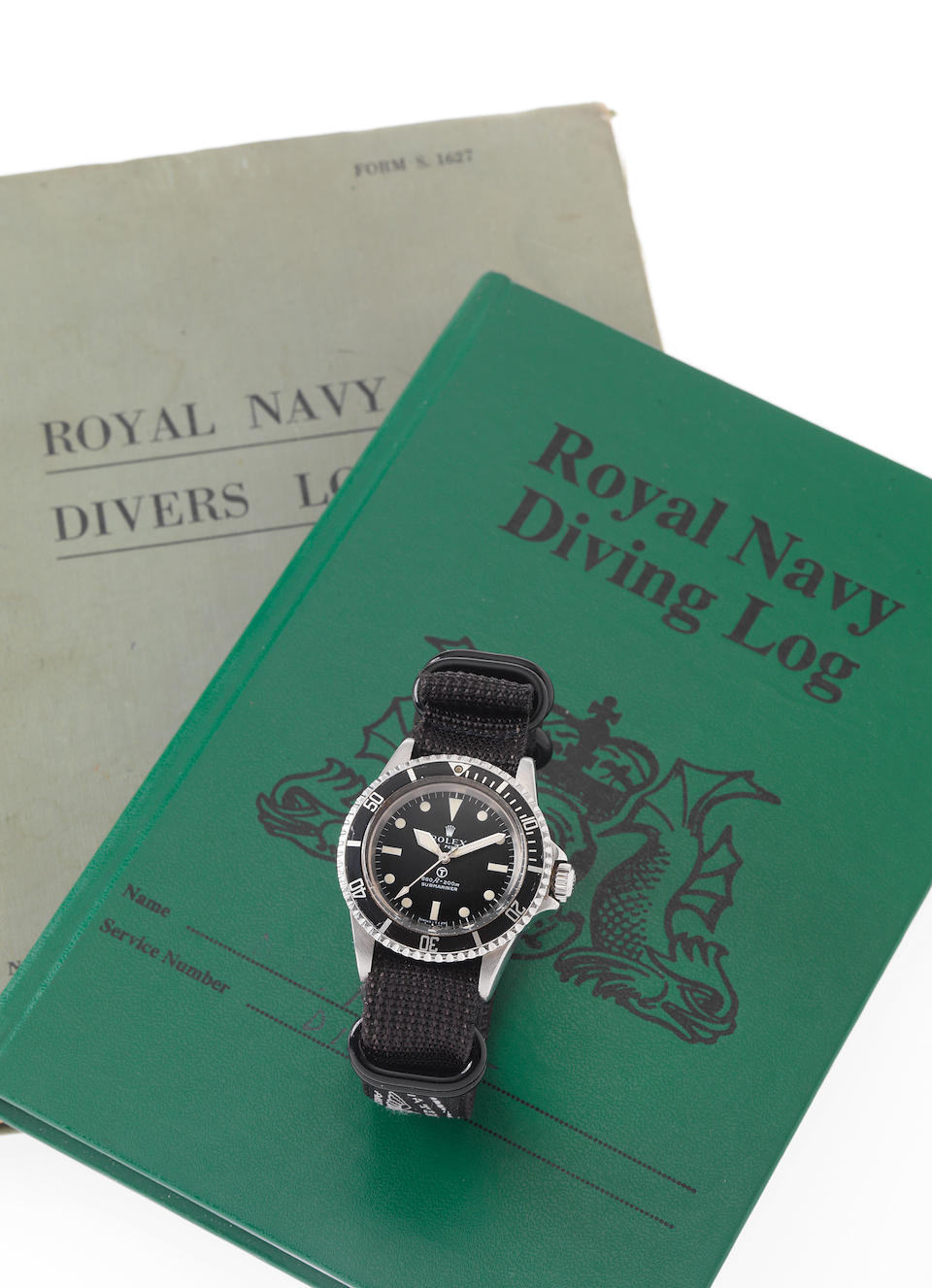 Rolex. A rare and historically interesting stainless steel automatic centre seconds Royal Navy Military Issue divers watch with Royal Navy Divers log book and photographic records relating to Military exercises including the Falklands WarSubmariner, Ref: 5513, Case No.3927165, Made in 1972, Issued in 1975