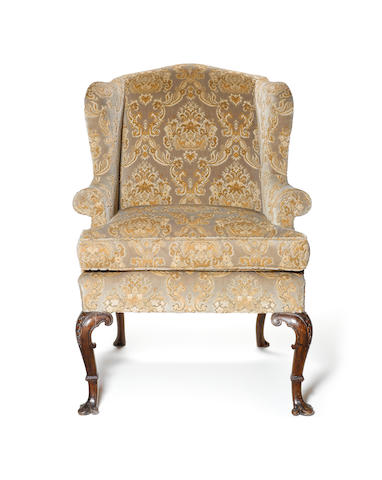 A Queen Anne carved walnut Wing Armchair