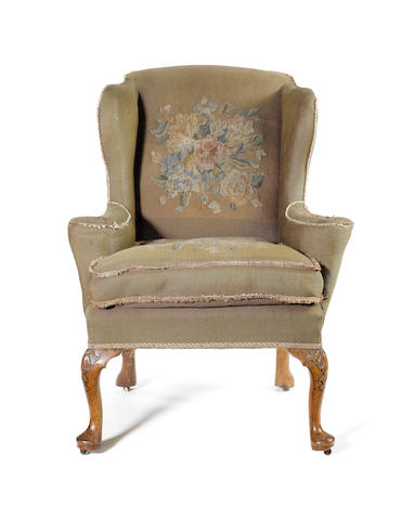 A George I carved walnut framed Wing Armchair