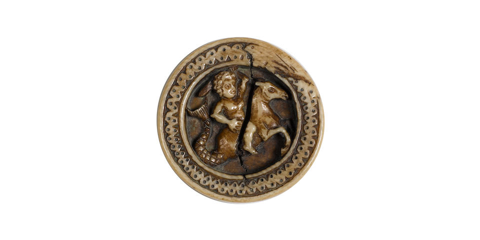 A French carved ivory medallion depicting a man riding a hippocampusprobably 12th century Rhenish