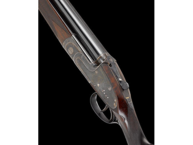 A fine light-weight 12-bore over-and-under sidelock ejector gun by J. Woodward, no. 7033 In a leather case