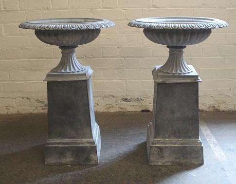 A pair of cast iron garden urns