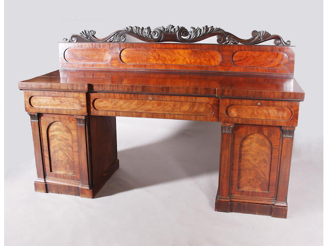 A George IV figured mahogany twin pedestal sideboard