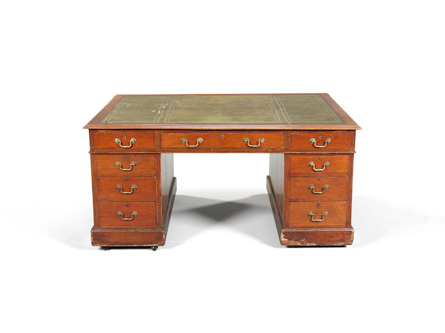 An early 20th Century mahogany partners' desk,with panelled cupboards to the reverse, 154 x 105 x 72cm.