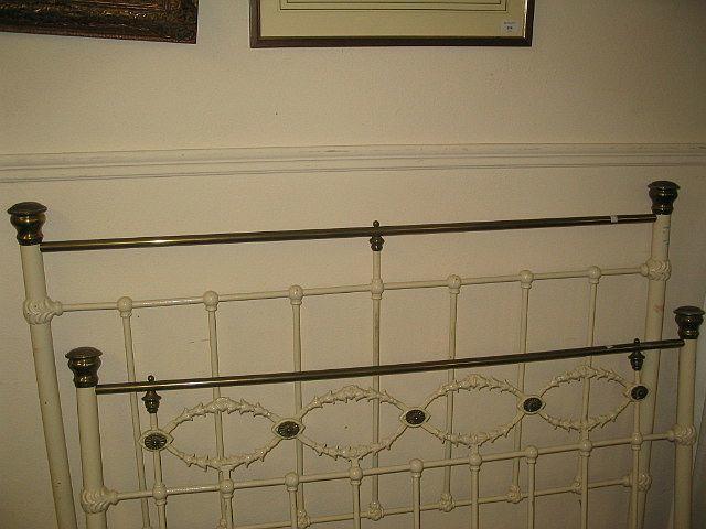 A 19th century painted and brass double bed