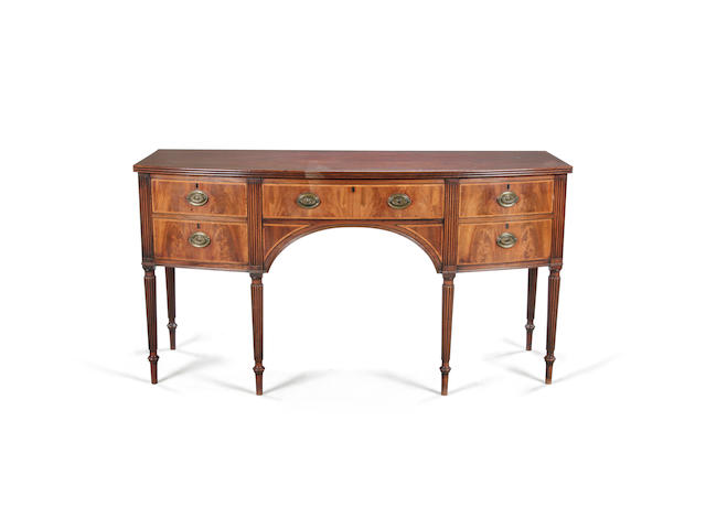 A late George III mahogany and crossbanded bowfront sideboard circa 1820
