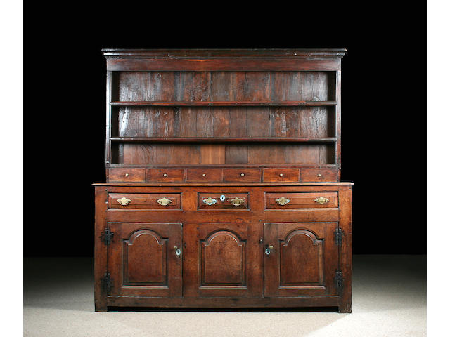 A mid 18th Century oak high dresser with rack