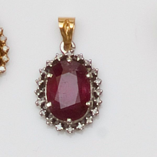A ruby and diamond cluster pendant