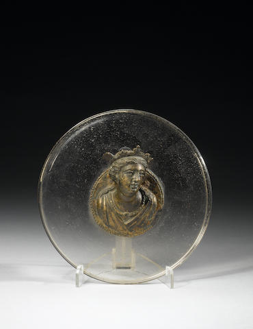 A Hellenistic bronze roundel with a bust