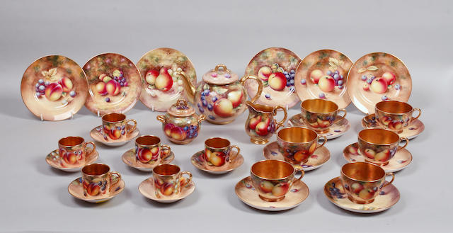 A late 20th century matched Royal Worcester tea and coffee set decorated with fruit,
