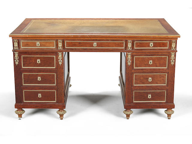 A late 19th century Directoire style plum pudding mahogany and ormolu mounted partner's desk circa 1900