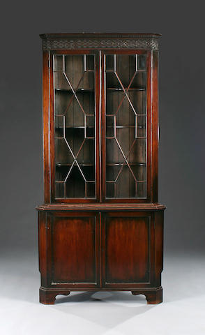 A George III-style mahogany standing corner cupboard, early 20th Century