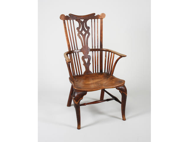 A late 18th century Thames Valley fruitwood and elm comb back elbow chair