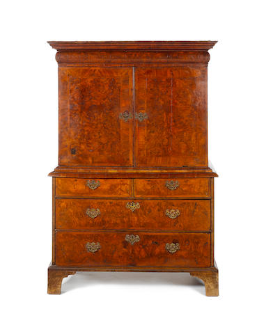 A George I walnut  crossbanded and featherbanded Cabinet on Chest
