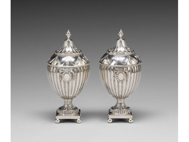 A matched pair of George III silver sugar vases and covers, London 1774, maker's mark SW probably that of Samuel Wood or Samuel White, one cover stamped with maker's mark only,  (2)