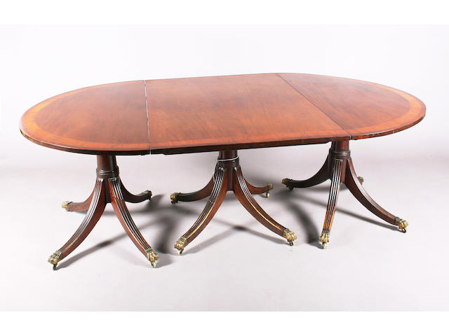 A George III style, mahogany triple pedestal 'D' end dining table,