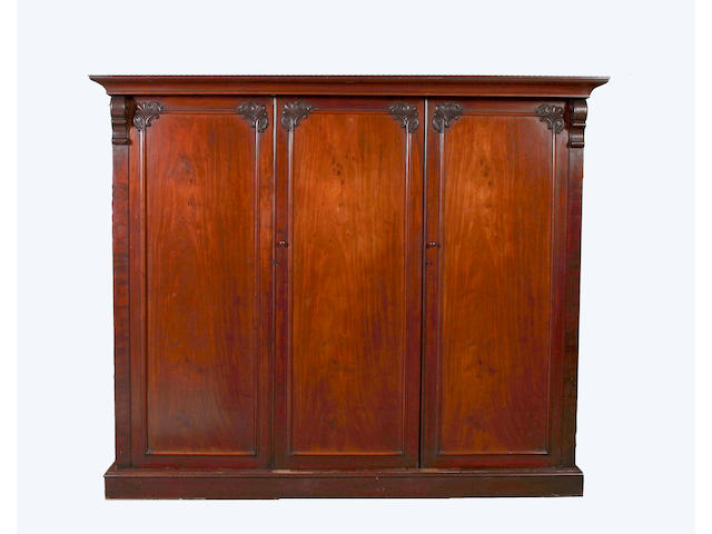 An early Victorian mahogany triple wardrobe,