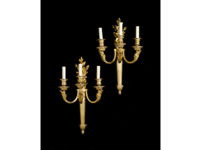 A pair of large late 19th century Louis XVI style gilt-bronze three-light wall appliques