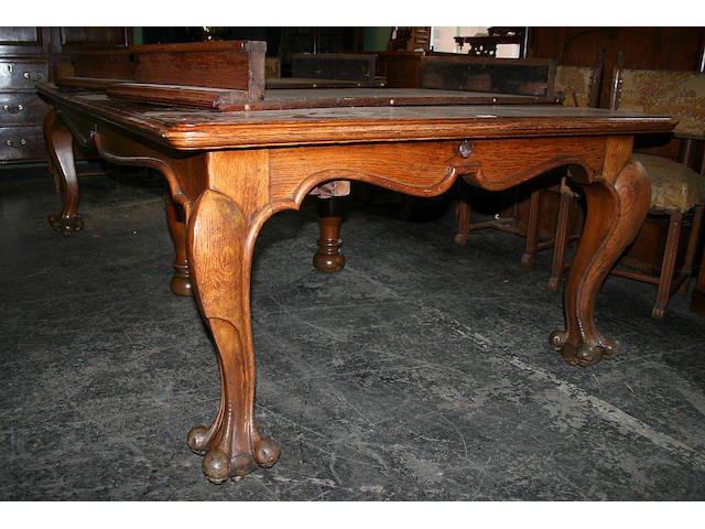 A large extending oak dining table, circa 1910