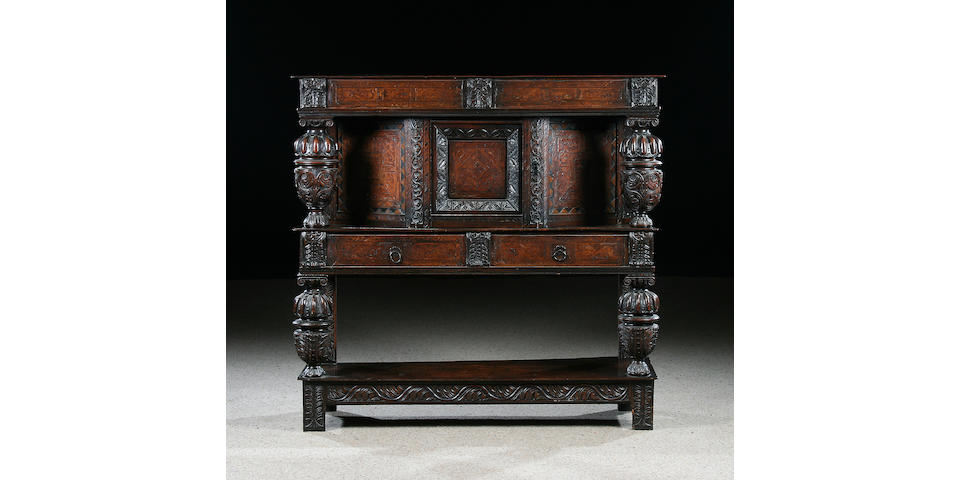 An early 17th Century oak and marquetry inlaid court cupboard