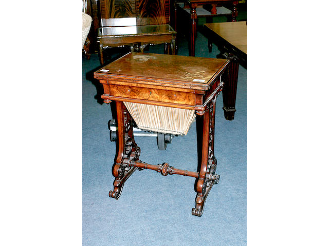 A mid 19th century walnut sewing and games table