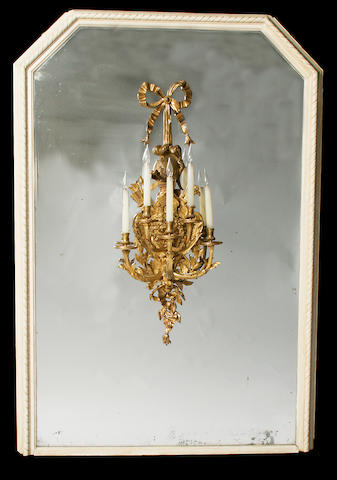 A late 19th century French gilt bronze five branch wall light mounted on a large painted wood pier mirror