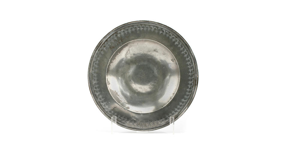 A rare early 17th Century punch decorated broad rim dish, circa 1600