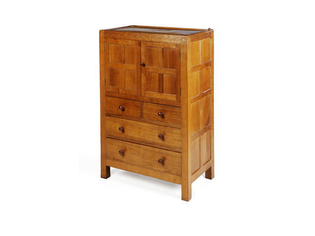 A 'Mouseman' oak tallboy excecuted in 1968, no longer produced,