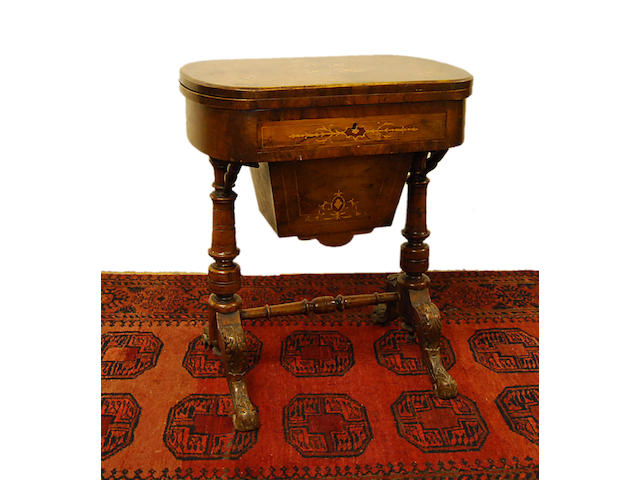 A Victorian walnut and inlaid work and games table