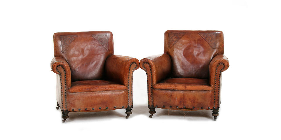 A pair of early 20th century tan leather upholstered club armchairs