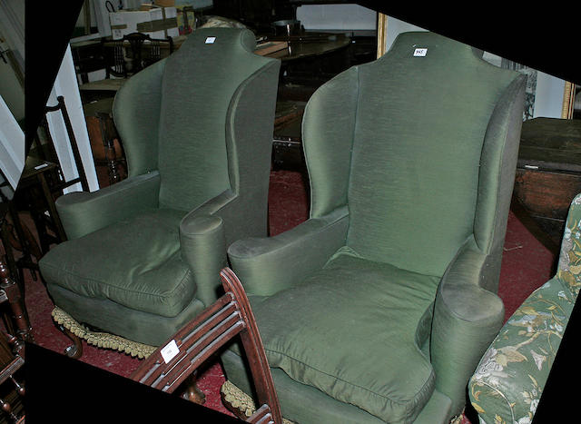 A pair of 20th Century shaped wing back armchairs,