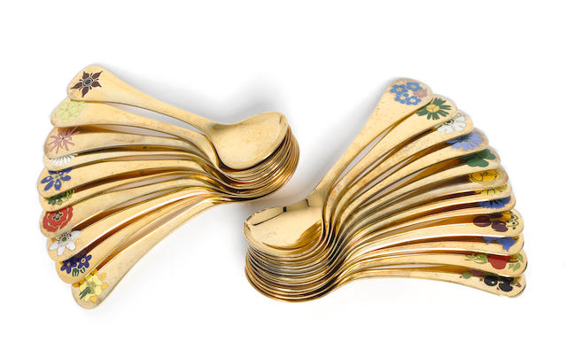 GEORG JENSEN: A collection of twenty two silver-gilt and enamelled year spoons, marked STERLING DENMARK.  (22)
