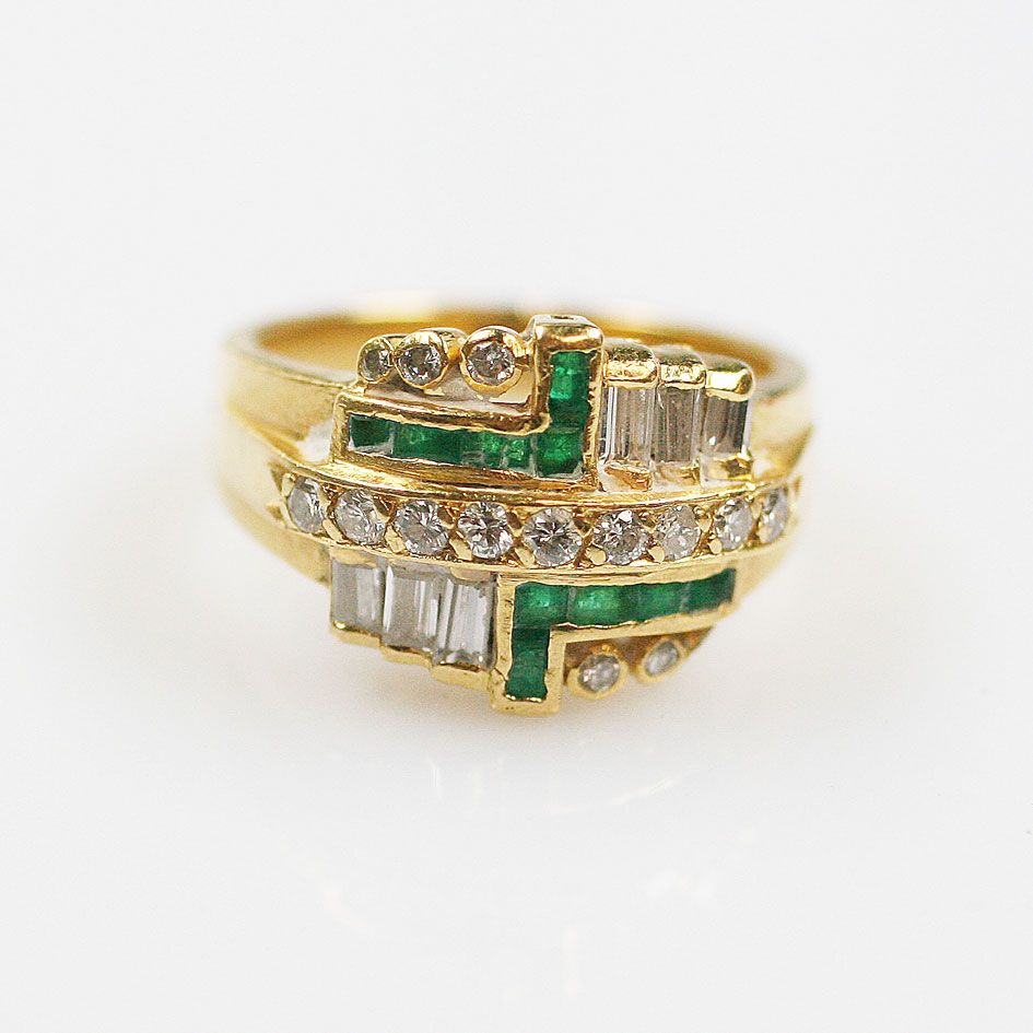 An emerald and diamond ring