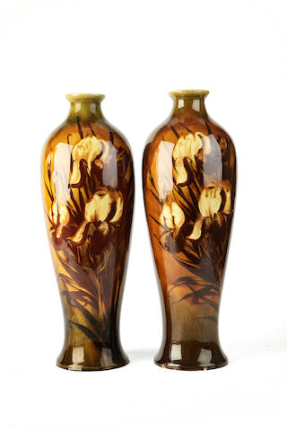 A pair of tall vases in the style of Linthorpe