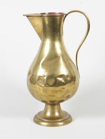 A brass baluster shaped church jug in the Pugin for Hardman style