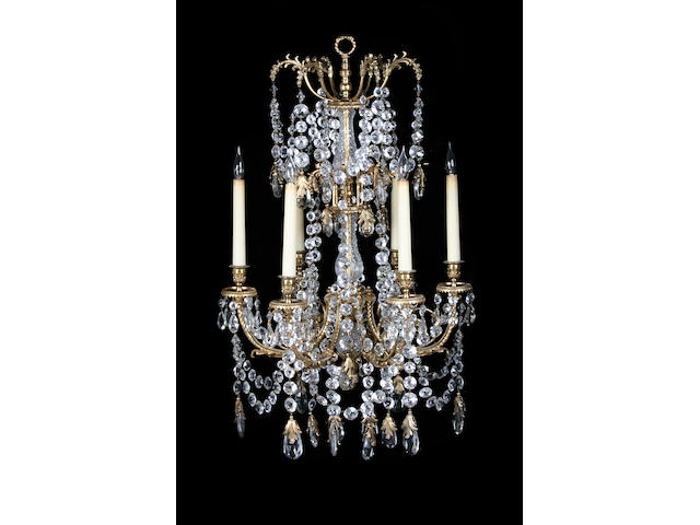 A pair of gilt metal and cut glass six light chandeliers