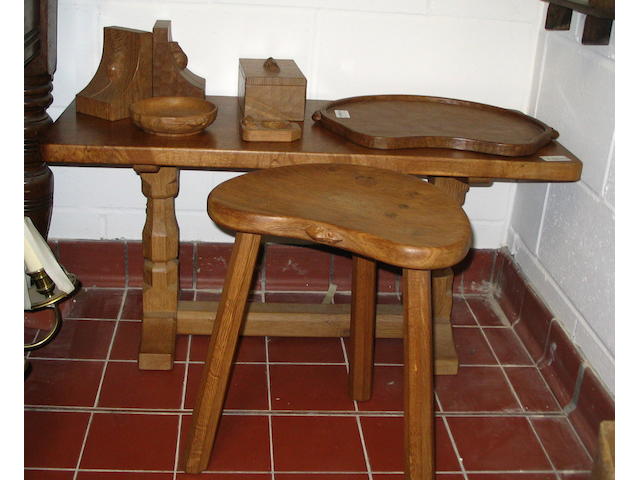 Robert "Mouseman" Thompson of Killun: A rectangular coffee table,on octagonal section end supports, 93cm long, a three-legged stool, a kidney-shaped tray, a pair of book ends, a rectangular box with lift-off lid, a sweetmeat dish and an ashtray. (8)
