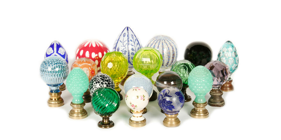 A collection of porcelain, opaque glass and clear glass newel post finials