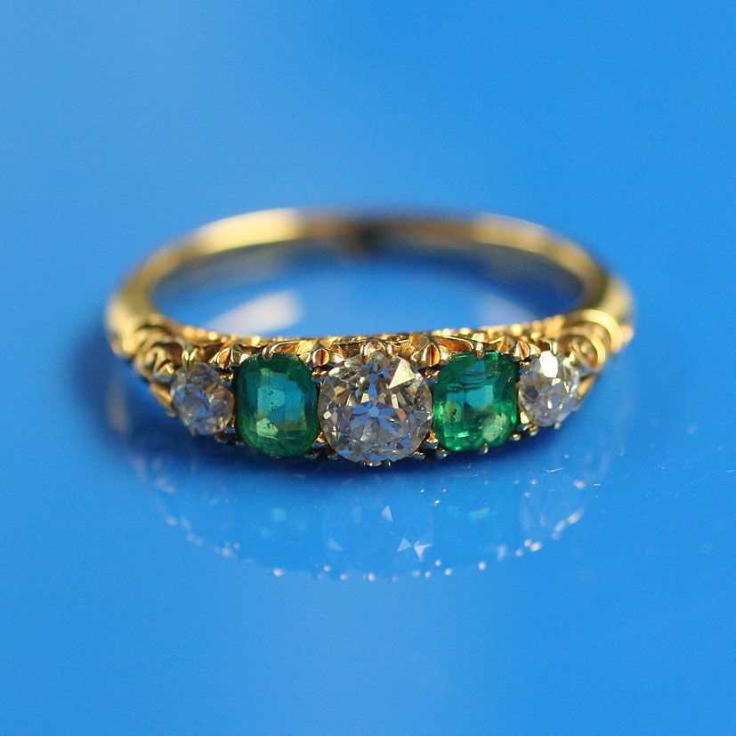 A five stone emerald and diamond ring