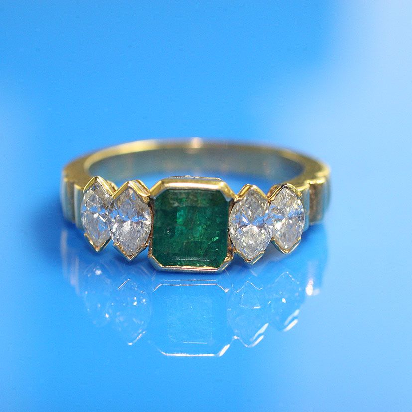 A emerald and diamond ring
