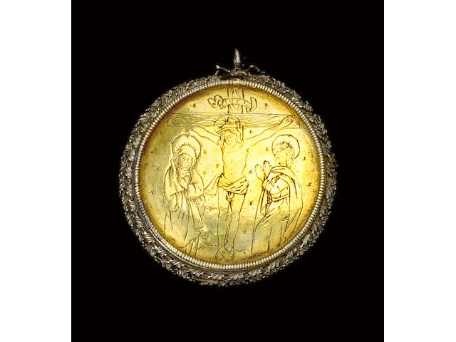 A fine and rare 15th century Flemish circular silver-gilt reliquary case depicting Saint Catherine of Alexanria