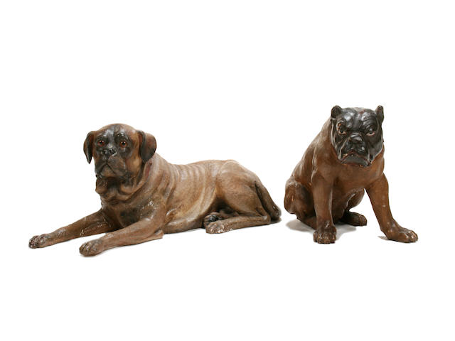 A large  carved wood and polychrome decorated model of a seated bulldog together with a painted terracotta model of a boxer dog