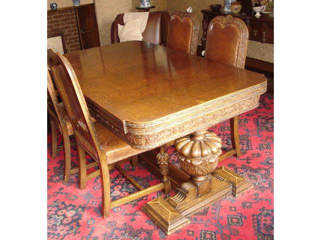 An early 20th century oak dining room suite