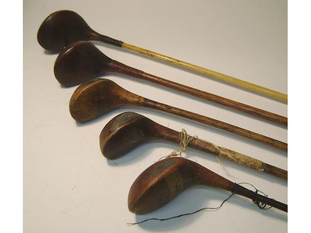 A quantity of mainly wooden shafted clubs in four golf bags