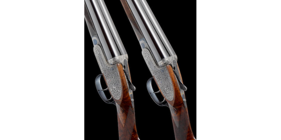 A fine pair of Kell-engraved 12-bore self-opening sidelock ejector guns by J. Purdey & Sons, no. 25256/7 In their leather motor-case, together with another leather motor-case with J. Purdey trade-label