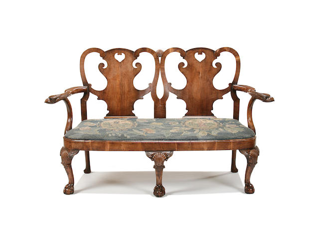 A late Victorian walnut double chair back sofa of George II style