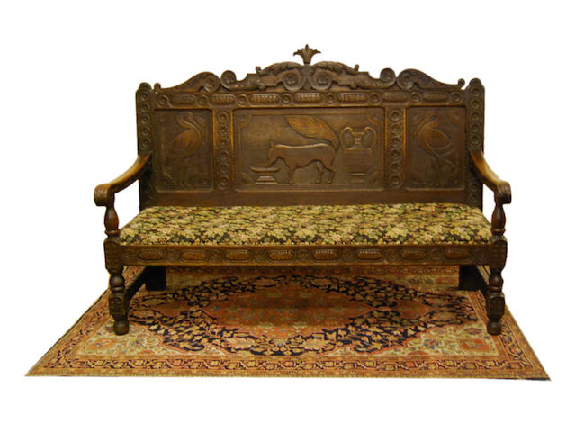 A Victorian carved oak settle