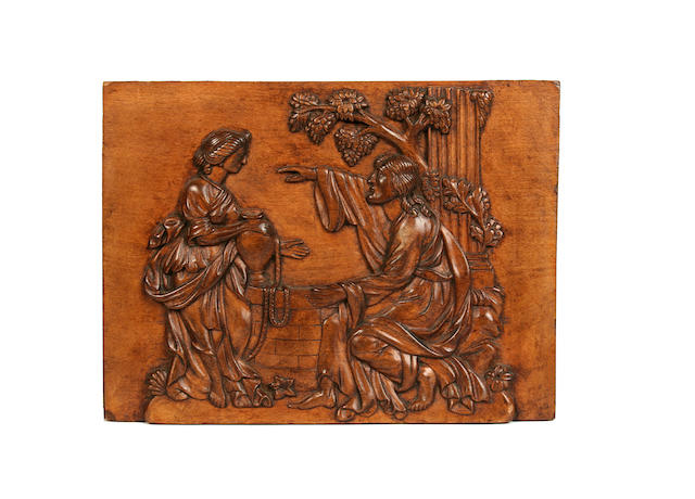 A 19th century Franco-Flemish relief carved fruitwood panel depicting Rebecca at the well with Christ