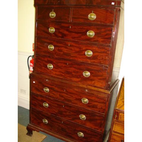 An 18th Century mahogany tallboy chest, the dentil moulded cornice over two short and three long drawers, within reeded canted corners, the base with pull-out slide and three long drawers on ogee bracket feet, 107cm wide