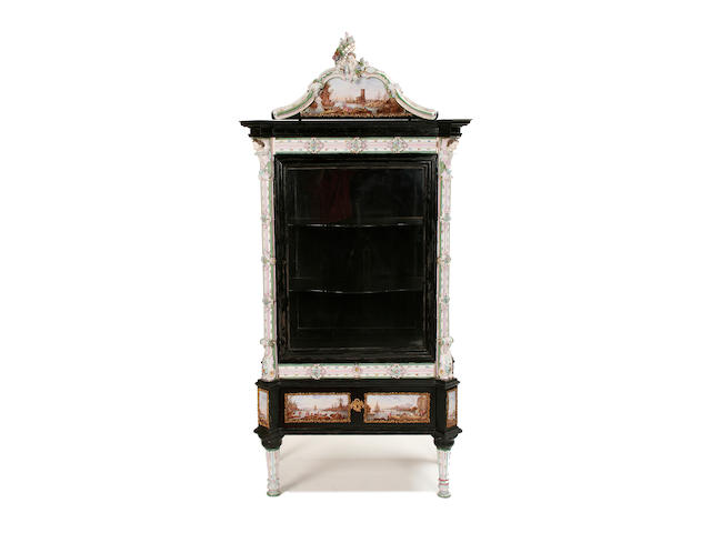 A good late 19th German ebonised and porcelain mounted display cabinet